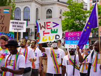 A group of Black refugees marches during Christopher Street Day (CSD) in Munich, Germany, on June 22, 2024, holding colorful signs advocatin...