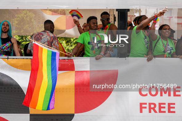 A group of Black participants on a parade truck during the Christopher Street Day (CSD) in Munich, Germany, on June 22, 2024, wear green t-s...