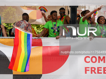 A group of Black participants on a parade truck during the Christopher Street Day (CSD) in Munich, Germany, on June 22, 2024, wear green t-s...