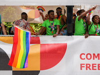 A group of Black participants on a parade truck during the Christopher Street Day (CSD) in Munich, Germany, on June 22, 2024, wear green t-s...