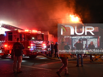 Flames erupt from multiple stores on John F. Kennedy Boulevard and reach 4-alarms as firefighters continue to battle numerous fires around t...