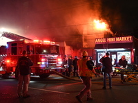 Flames erupt from multiple stores on John F. Kennedy Boulevard and reach 4-alarms as firefighters continue to battle numerous fires around t...