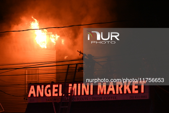 Flames erupt from multiple stores on John F. Kennedy Boulevard and reach 4-alarms as firefighters continue to battle numerous fires around t...