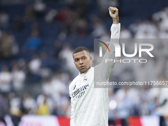 Kylian Mbappe of Real Madrid greets fans during the La Liga 2024/25 match between Real Madrid and Osasuna at Santiago Bernabeu Stadium in Ma...