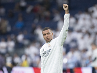 Kylian Mbappe of Real Madrid greets fans during the La Liga 2024/25 match between Real Madrid and Osasuna at Santiago Bernabeu Stadium in Ma...