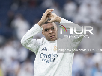 Kylian Mbappe of Real Madrid warms up during the La Liga 2024/25 match between Real Madrid and Osasuna at Santiago Bernabeu Stadium in Madri...