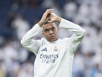 Kylian Mbappe of Real Madrid warms up during the La Liga 2024/25 match between Real Madrid and Osasuna at Santiago Bernabeu Stadium in Madri...