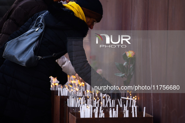 People light candles at Berlin Wall Memorial after the commemoration ceremony marking the 35th anniversary of the fall of the Berlin Wall. B...