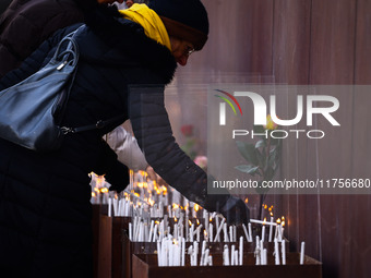 People light candles at Berlin Wall Memorial after the commemoration ceremony marking the 35th anniversary of the fall of the Berlin Wall. B...