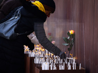 People light candles at Berlin Wall Memorial after the commemoration ceremony marking the 35th anniversary of the fall of the Berlin Wall. B...