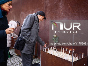 People light candles at Berlin Wall Memorial after the commemoration ceremony marking the 35th anniversary of the fall of the Berlin Wall. B...