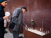 People light candles at Berlin Wall Memorial after the commemoration ceremony marking the 35th anniversary of the fall of the Berlin Wall. B...