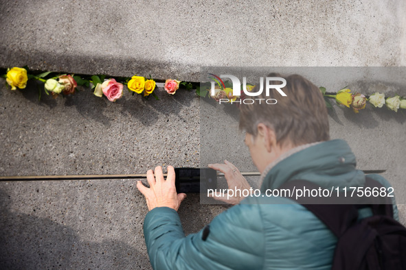 Flowers at Berlin Wall Memorial after the commemoration ceremony marking the 35th anniversary of the fall of the Berlin Wall. Berlin, German...