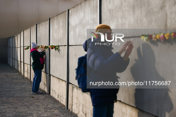 Flowers at Berlin Wall Memorial after the commemoration ceremony marking the 35th anniversary of the fall of the Berlin Wall. Berlin, German...