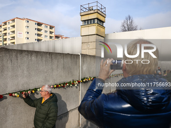 Flowers at Berlin Wall Memorial after the commemoration ceremony marking the 35th anniversary of the fall of the Berlin Wall. Berlin, German...