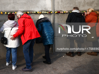 Flowers at Berlin Wall Memorial after the commemoration ceremony marking the 35th anniversary of the fall of the Berlin Wall. Berlin, German...