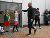 Wayne Rooney, manager of Plymouth Argyle, gives a high-five to a supporter during the Sky Bet Championship match between Derby County and Pl...