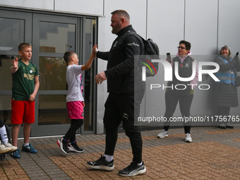 Wayne Rooney, manager of Plymouth Argyle, gives a high-five to a supporter during the Sky Bet Championship match between Derby County and Pl...