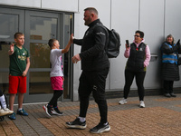 Wayne Rooney, manager of Plymouth Argyle, gives a high-five to a supporter during the Sky Bet Championship match between Derby County and Pl...