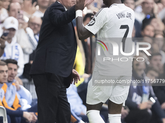 Vinicius Jr of Real Madrid celebrates a goal with Real Madrid coach Carlo Ancelotti during the La Liga 2024/25 match between Real Madrid and...