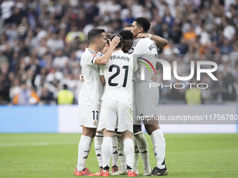 In Madrid, Spain, on November 9, several Real Madrid players celebrate a goal during the La Liga 2024/25 match between Real Madrid and Osasu...