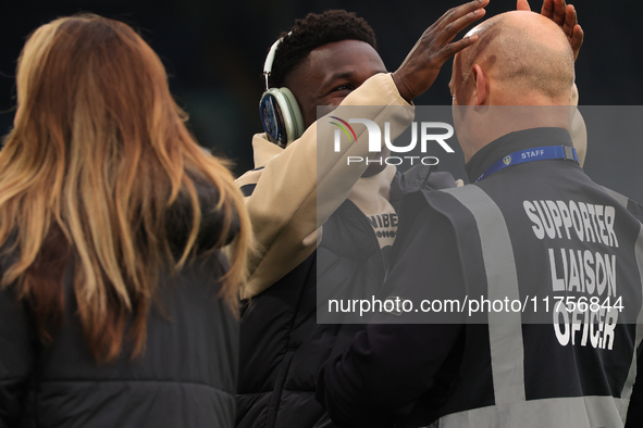 Willy Gnonto (Leeds United) rubs the head of a supporter liaison officer before the Sky Bet Championship match between Leeds United and Quee...