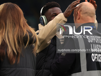 Willy Gnonto (Leeds United) rubs the head of a supporter liaison officer before the Sky Bet Championship match between Leeds United and Quee...