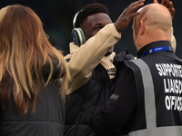 Willy Gnonto (Leeds United) rubs the head of a supporter liaison officer before the Sky Bet Championship match between Leeds United and Quee...