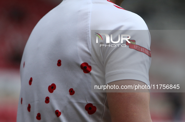 Sunderland goalkeeper Simon Moore has 'Lest We Forget' printed on his warm-up shirt during the Sky Bet Championship match between Sunderland...