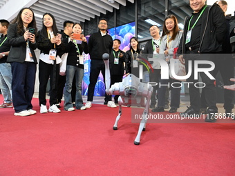 Visitors watch a robot dog perform in front of the Zhejiang Pavilion of the 7th China International Import Expo in Shanghai, China, on Novem...