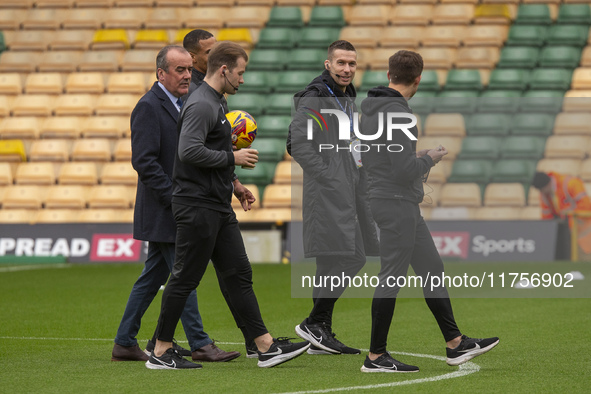 Match officials inspect the pitch before the Sky Bet Championship match between Norwich City and Bristol City at Carrow Road in Norwich, Eng...