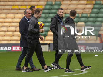 Match officials inspect the pitch before the Sky Bet Championship match between Norwich City and Bristol City at Carrow Road in Norwich, Eng...