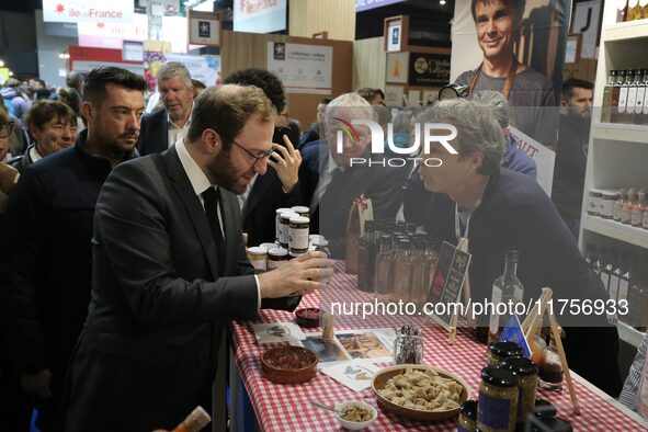 France's Minister for the Economy, Finance and Industry, Antoine Armand, speaks to personnel at the ''Benoit Badin'' condiments stand as he...