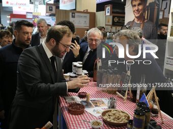 France's Minister for the Economy, Finance and Industry, Antoine Armand, speaks to personnel at the ''Benoit Badin'' condiments stand as he...