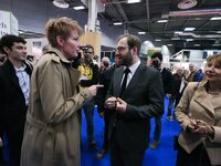 France's Minister for the Economy, Finance and Industry, Antoine Armand (center), speaks with French journalist Natacha Polony (left) as he...