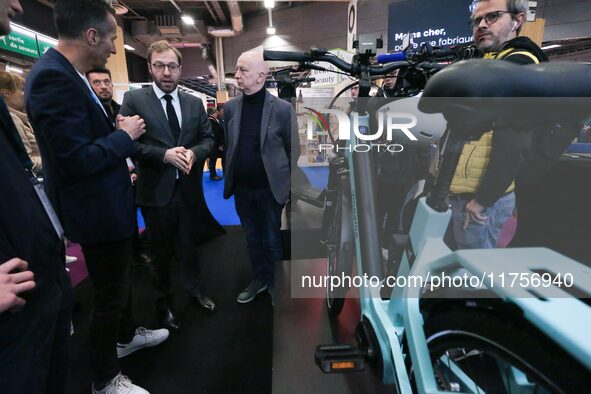 France's Minister for the Economy, Finance and Industry, Antoine Armand, speaks with personnel at a stand showcasing an Ymagine electric bic...