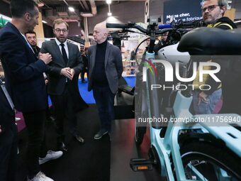 France's Minister for the Economy, Finance and Industry, Antoine Armand, speaks with personnel at a stand showcasing an Ymagine electric bic...