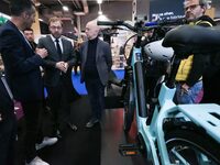 France's Minister for the Economy, Finance and Industry, Antoine Armand, speaks with personnel at a stand showcasing an Ymagine electric bic...