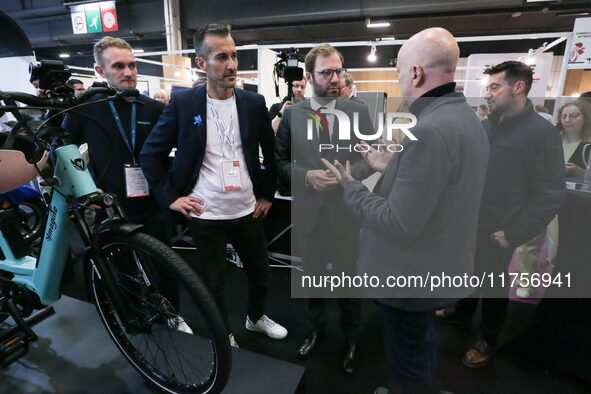 France's Minister for the Economy, Finance and Industry, Antoine Armand, speaks with personnel at a stand showcasing an Ymagine electric bic...