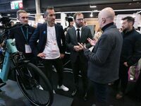 France's Minister for the Economy, Finance and Industry, Antoine Armand, speaks with personnel at a stand showcasing an Ymagine electric bic...