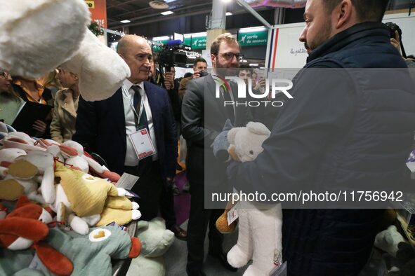 France's Minister for the Economy, Finance and Industry, Antoine Armand, examines plush toys at the ''Les Petites Maries'' brand's stand as...