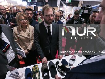 France's Minister for the Economy, Finance and Industry, Antoine Armand, speaks to personnel at the ''Airplum'' brand's stand showcasing sli...