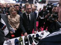 France's Minister for the Economy, Finance and Industry, Antoine Armand, speaks to personnel at the ''Airplum'' brand's stand showcasing sli...