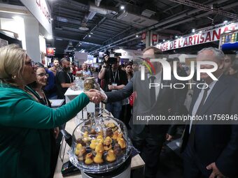 France's Minister for the Economy, Finance and Industry, Antoine Armand, samples pastries at the ''Les Petits Bouchon'' brand's stand as he...