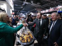 France's Minister for the Economy, Finance and Industry, Antoine Armand, samples pastries at the ''Les Petits Bouchon'' brand's stand as he...