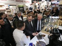 France's Minister for the Economy, Finance and Industry, Antoine Armand (center), examines watches made by the French watch manufacturing br...