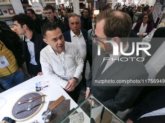 France's Minister for the Economy, Finance and Industry, Antoine Armand (center), examines watches made by the French watch manufacturing br...