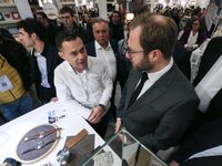 France's Minister for the Economy, Finance and Industry, Antoine Armand (center), examines watches made by the French watch manufacturing br...