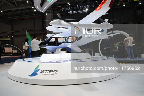 Visitors visit the Range Aviation booth at the ''Future Low Altitude Travel'' area of the Automobile Pavilion at the 7th China International...