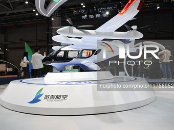 Visitors visit the Range Aviation booth at the ''Future Low Altitude Travel'' area of the Automobile Pavilion at the 7th China International...